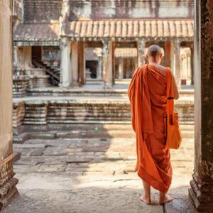 Cambodia Buddhist monk exploring ancient courtyards-of-temple-complex-Angkor-Wat-in-Siem-Reap