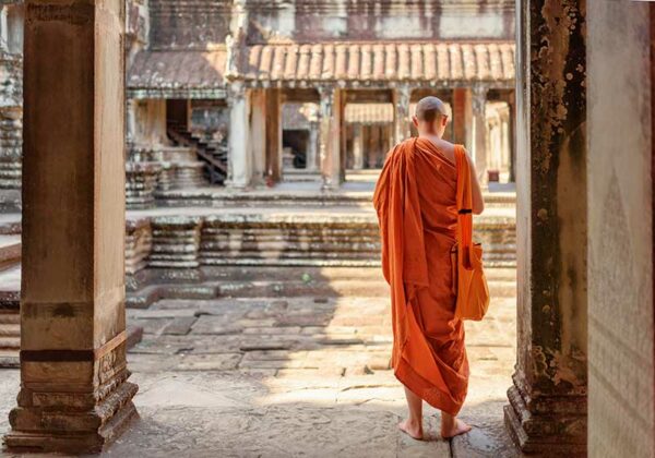 Cambodia Buddhist monk exploring ancient courtyards-of-temple-complex-Angkor-Wat-in-Siem-Reap