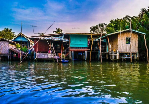 Stilt houses built above river Mae Klong